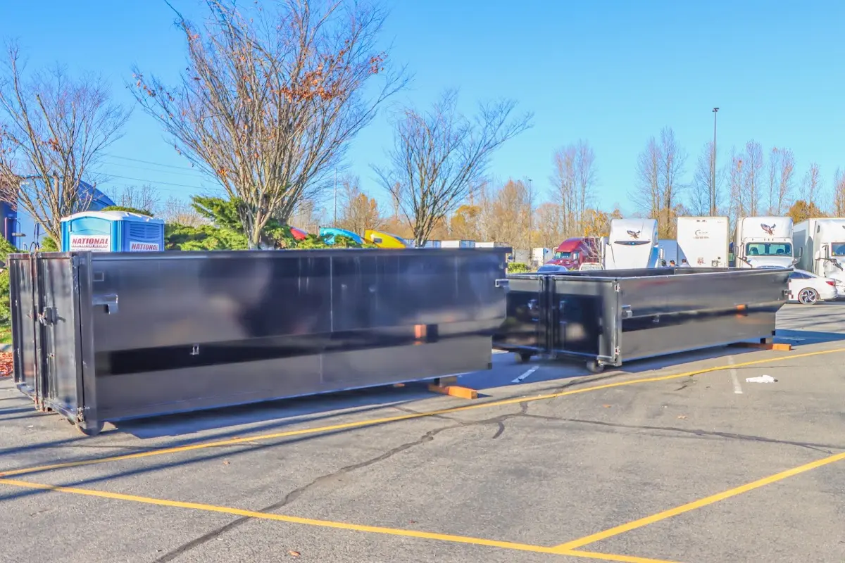 Professional dumpster rental service with roll-off container on residential driveway in South Lyon